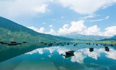 Boats on Lake Santa Croce in Alpago, Italy